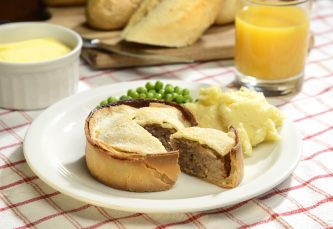 Galloway scotch pies cooked with peas and mashed potato
